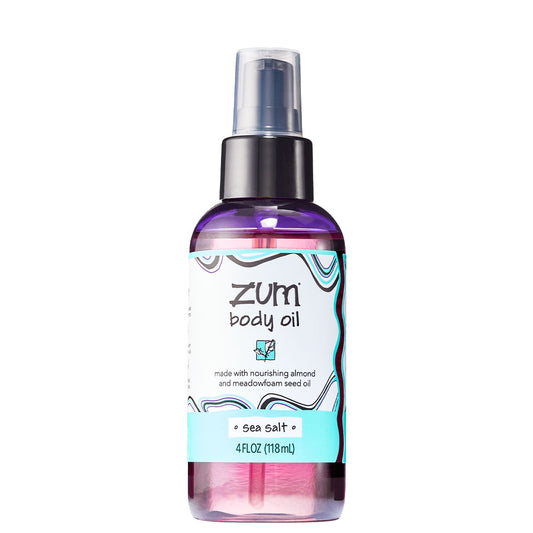 Cylinder bottle with pump top and cap containing sea salt scented body oil