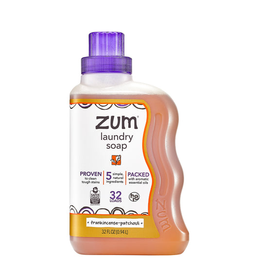 Plastic bottle with wavy right edge and screw top cap containing frankincense & patchouli laundry liquid