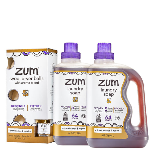 Two Zum laundry soap bottles and a dryer ball kit on a white background