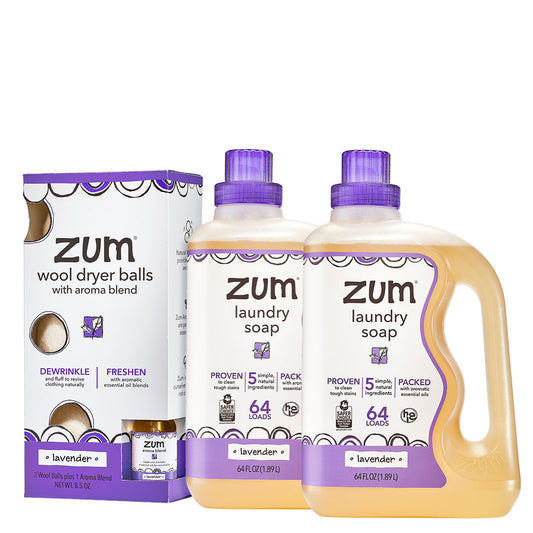 Two lavender Laundry Soap bottles and Wool Dryer Ball Kit on a white background