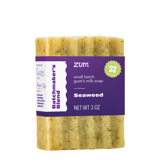 A 3 oz bar of Zum Seaweed goat milk soap, featuring a textured pale yellow-green soap bar with visible green seaweed flecks, wrapped in a purple and white paper label.