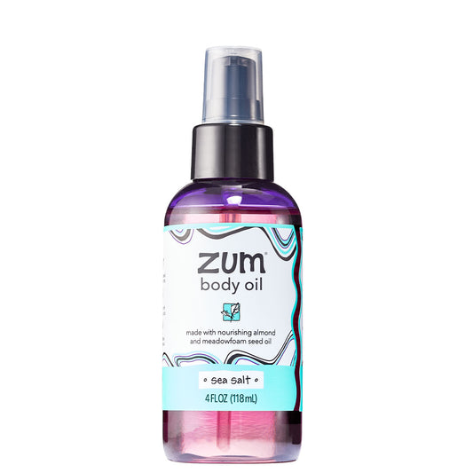 Cylinder bottle with pump top and cap containing sea salt scented body oil