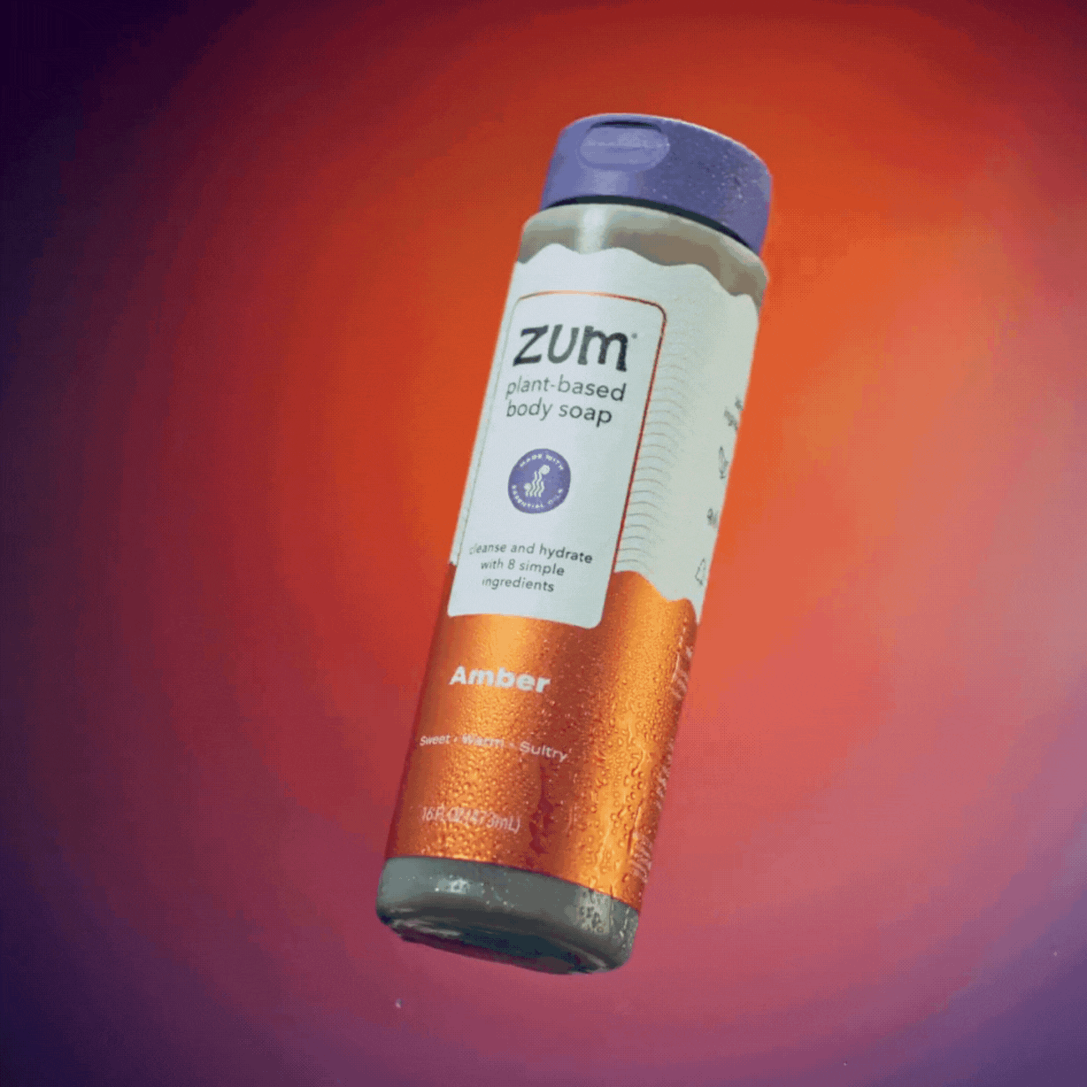 Amber Body Soap Bottle spinning in air with water hitting it