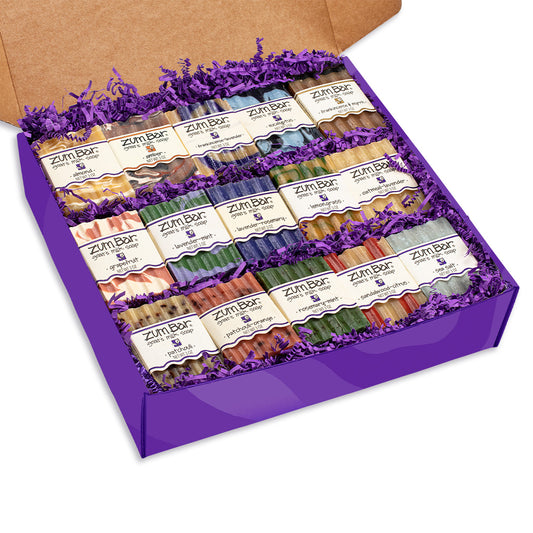 Large purple gift box containing 15 assorted Zum Bar Goat's Milk Soaps packed in purple crinkle paper.