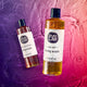 Sea Salt and Frankincense & Myrrh scented body wash bottles flying in the air landing on purple to pink gradient water.