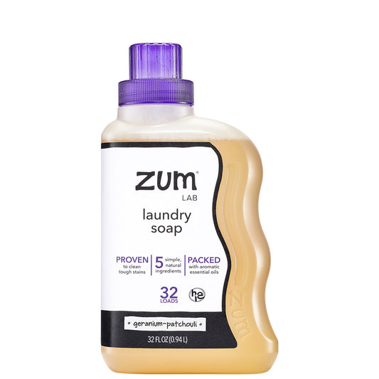 Plastic bottle with purple cap containing geranium-patchouli scented laundry soap liquid