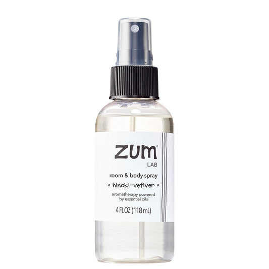 A 4 fl oz clear bottle of Zum Lab Room & Body Spray with a black spray cap and a white label, shown on a solid white background.
