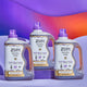Three Frankincense & Myrrh 64 fl oz Laundry Soaps with three wavy shapes in the back in the colors light purple, orange to purple gradient, and purple.