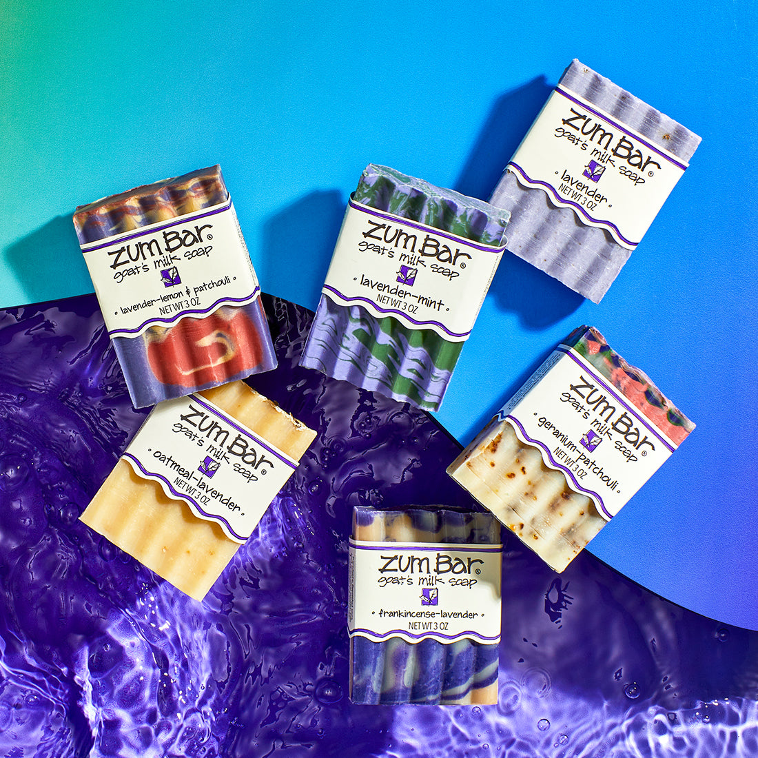 Lavender-Lemon & Patchouli, Oatmeal-Lavender, Lavender-Mint, Lavender, Frankincense-Lavender, Geranium-Patchouli Bar Soaps half on a blue gradient wavy shape, and purple water underneath.