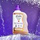 A Frankincense-Patchouli 32 fl oz Laundry Soap on a clear acrylic box with water falling behind it with a purple background.