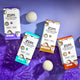 Lavender, Sea Salt, Frankincense & Myrrh, and Amber Wool Dryer Ball Kits laying half on a light purple shelf, half on purple water. Three scattered wool balls surrounded them.