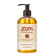 A 12 fl oz bottle of Zum Hand Soap in the Holiday Almond scent, featuring a clear bottle filled with golden-yellow liquid, a black pump dispenser, and a cream-colored label with red and brown text.