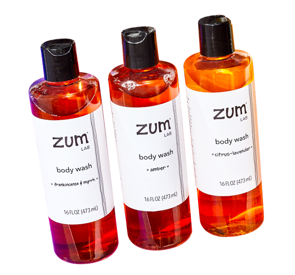 Frankincense & Myrrh, Amber, and Citrus-Lavender body wash bottles standing at an angle.