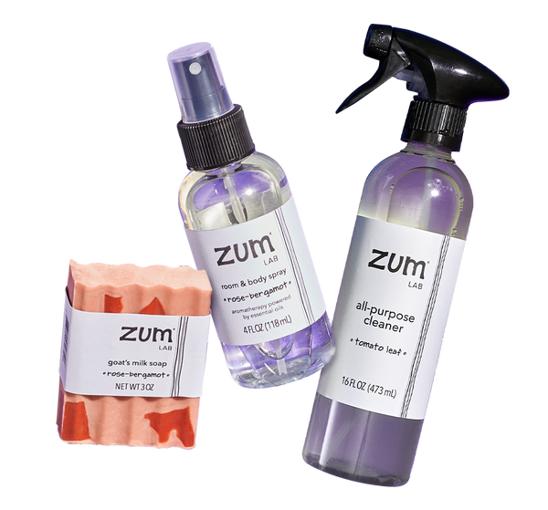 Rose-Bergamot label goat's milk bar soap, rom & body spray bottle, and Tomato Leaf All-Purpose Cleaner bottle with a sprayer.