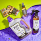 3125 laundry soap, all-purpose cleaner, bar soap and room & body spray all laying in purple water 