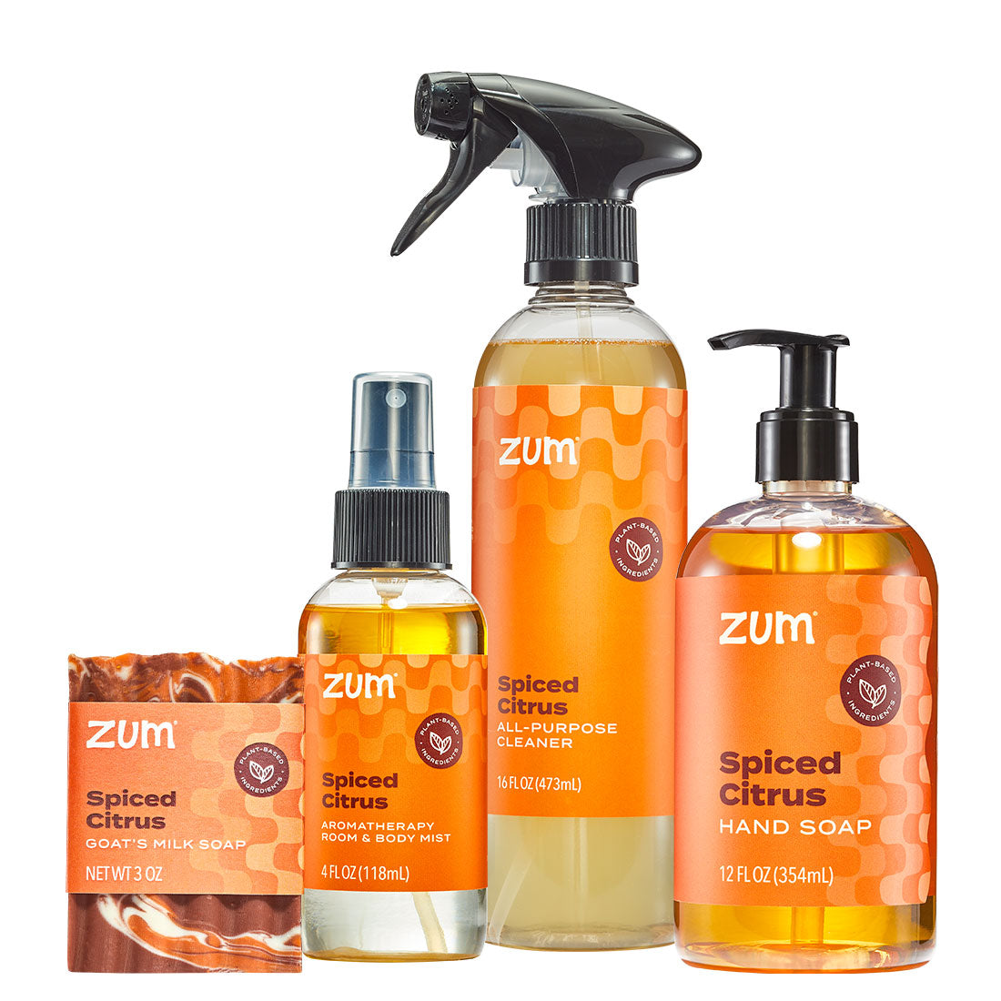A set of Zum Spiced Citrus body and hand care products on a white background, including a hand soap bottle, a body wash bottle, an all-purpose cleaner spray bottle, and a soap bar.