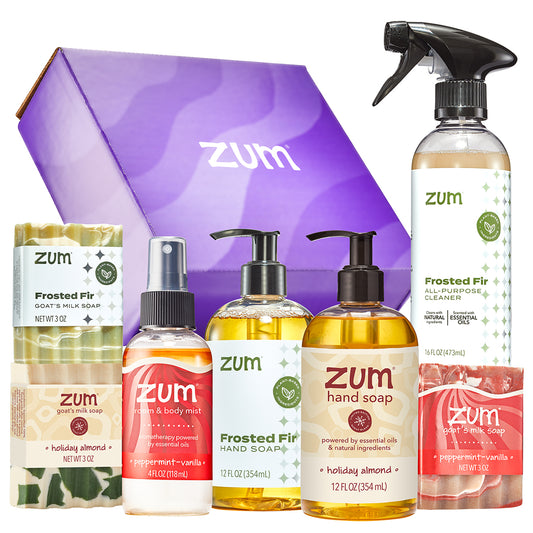 A Zum gift set featuring a purple branded box and an assortment of Holiday Zum home care products.