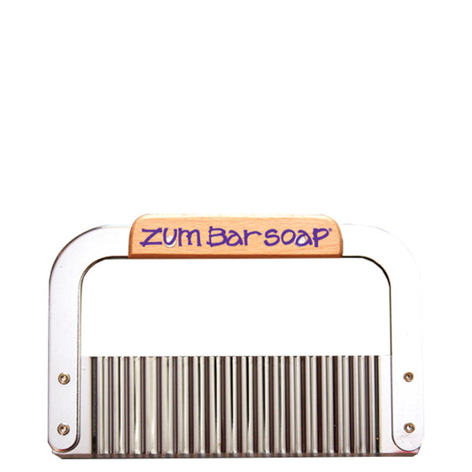 Silver bulk brick wavy cutter with wood grip with the purple words Zum Bar Soap on it.