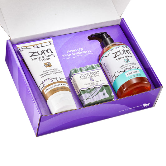 Purple Gift Box filled with a Zum Hand & Body Lotion Tube, a Zum Bar Goat's Milk Soap, and a Zum Hand Soap Bottle in varying scents.