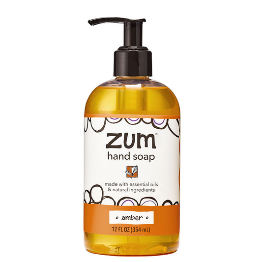 Clear hand soap bottle with black and white label filled with Amber scented liquid hand soap.