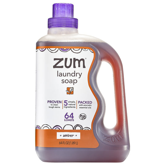 Amber laundry soap in a clear 64 oz bottle with purple lid.