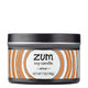 7 oz Amber Candle in a black tin with brown and white label that has circular designs.
