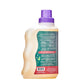 Back of clear laundry soap bottle with wave on side and purple cap.