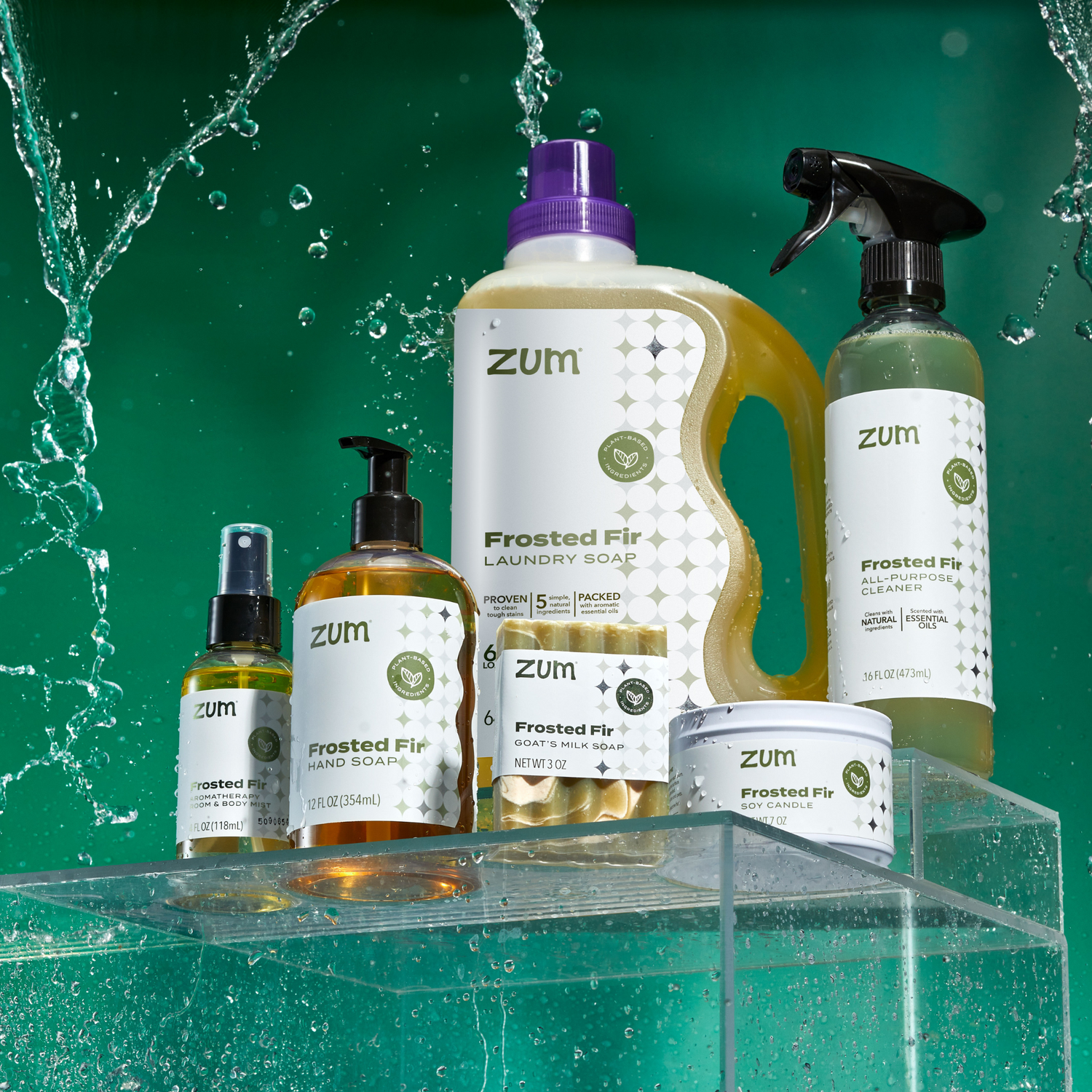 Frosted Fir Family of products on clear shelves with green background and water falling around product.