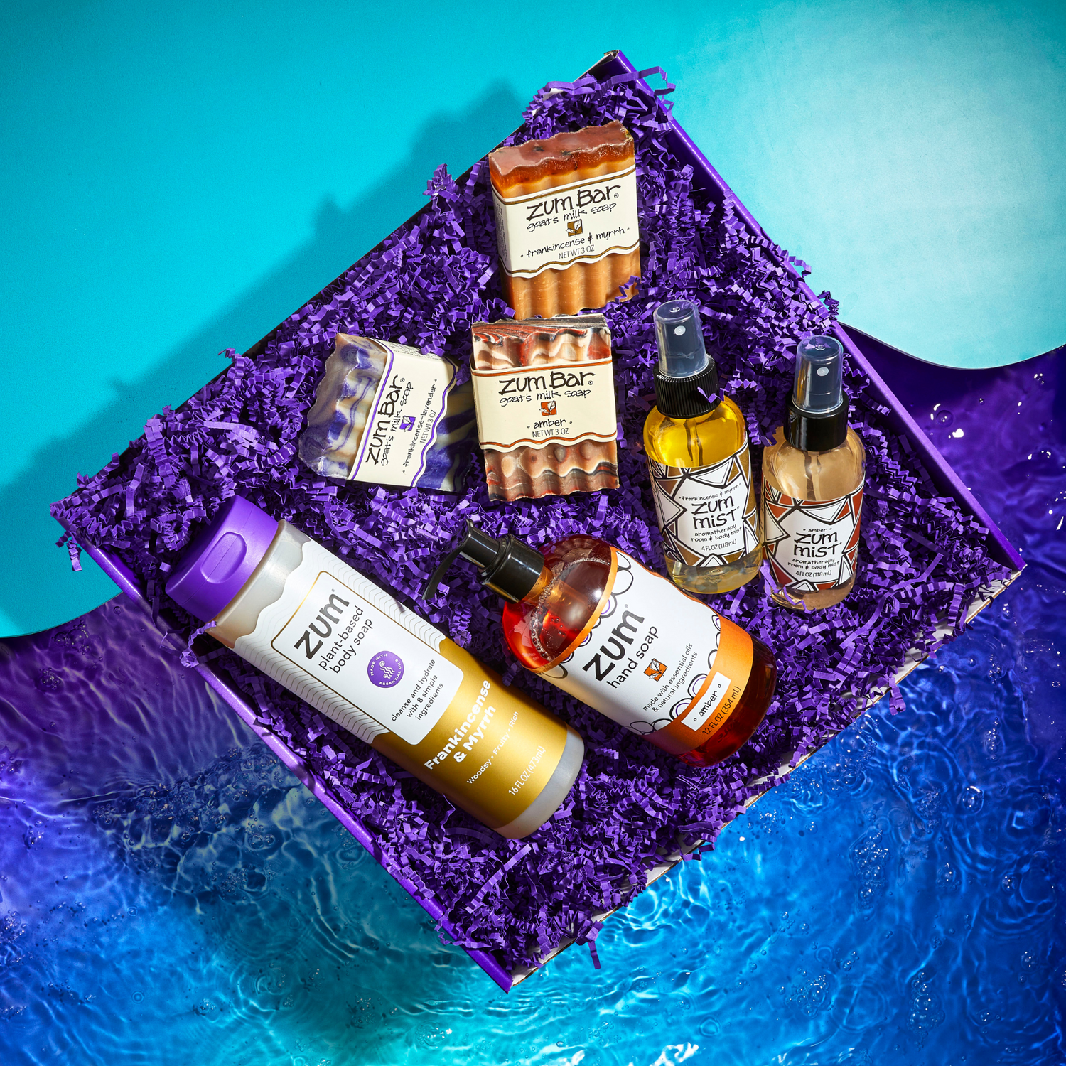 Zum woodsy products on a purple textured surface with a blue gradient background