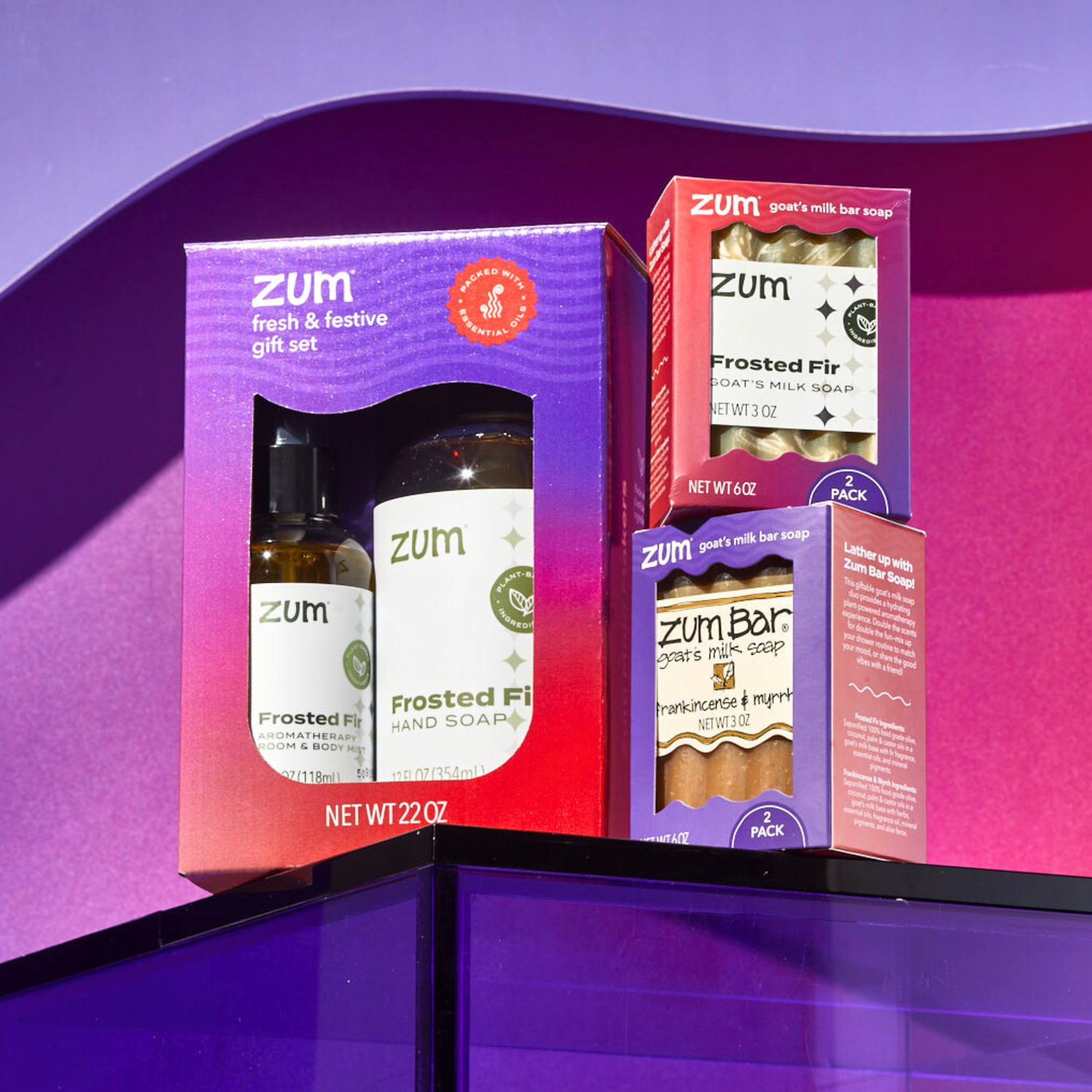 Zum gift set with various products on a purple and pink gradient background