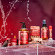 Zum products including hand soap, candles, and body wash on a red background with water splashes.