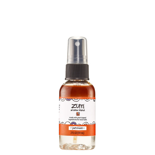 Small bottle with sprayer top containing patchouli scented aroma blend for wool dryer balls.