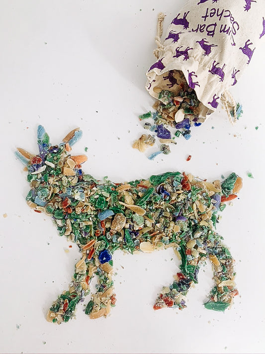 Muslin bag spilling open to create a goat shape out of soap shavings.