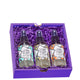Square box containing three Zum room & body mists nestled in purple crinkle.