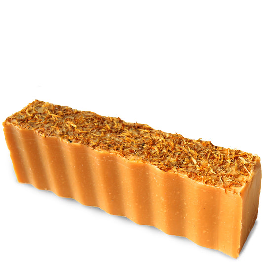 Topped with leaves orange colored wavy rectangular 45 ounce brick of tea tree and citrus scented Zum Bar Soap