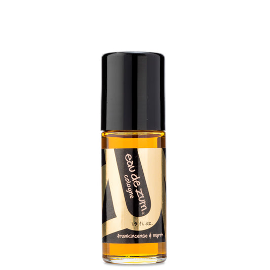 Glass bottle with rollerball containing frankincense & myrrh eau de zum cologne