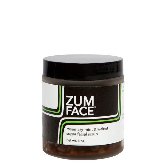 Frosted glass jar with lid that contains rosemary-mint and walnut sugar facial scrub.