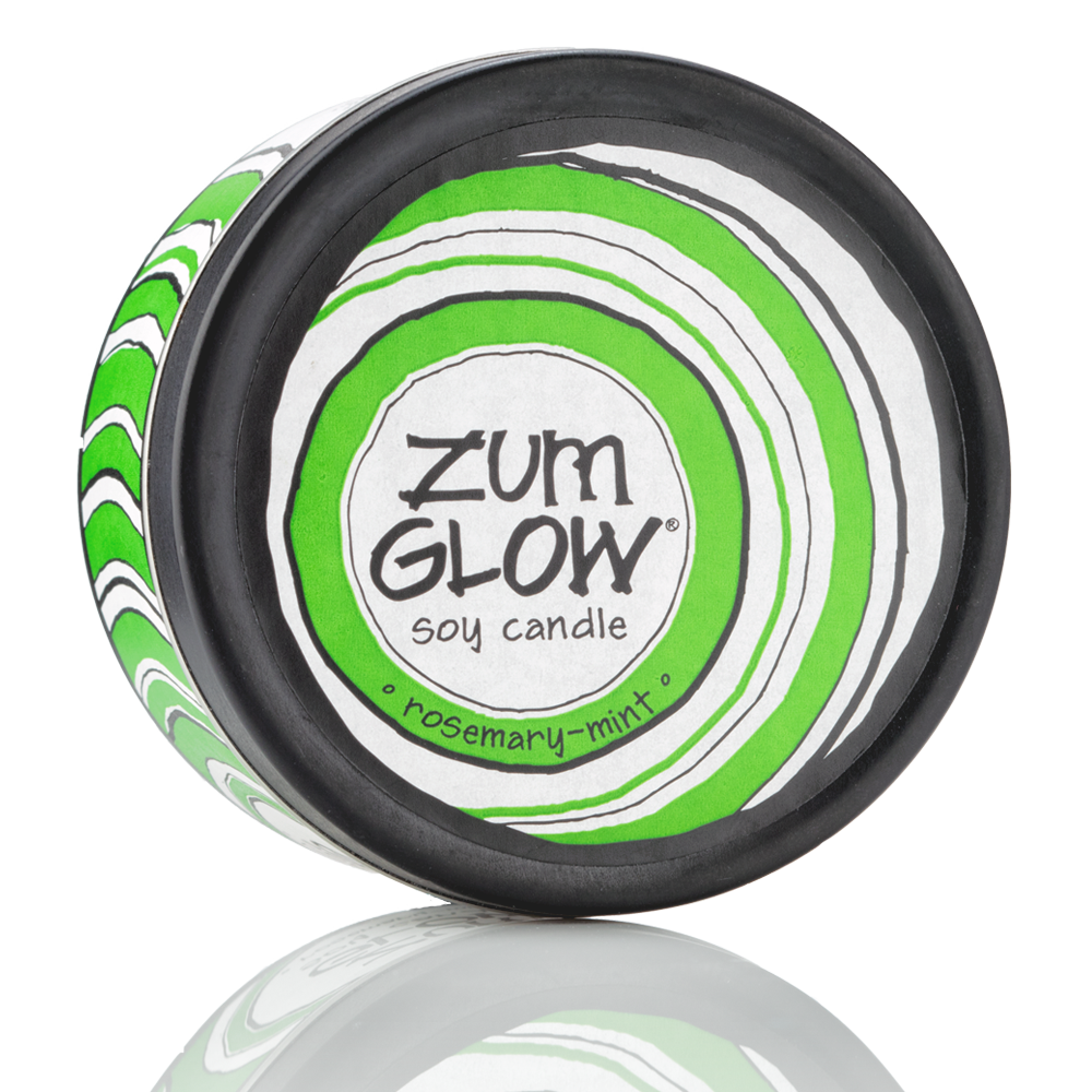 Top view 7 oz Rosemary-Mint Candle in a black tin with green and white label that has circular designs.