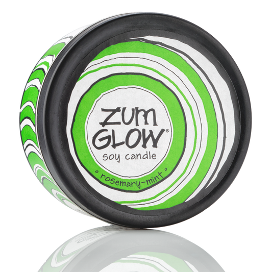 Top view 7 oz Rosemary-Mint Candle in a black tin with green and white label that has circular designs.