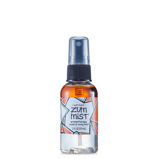 Small round bottle with black sprayer containing patchouli scented room and body mist